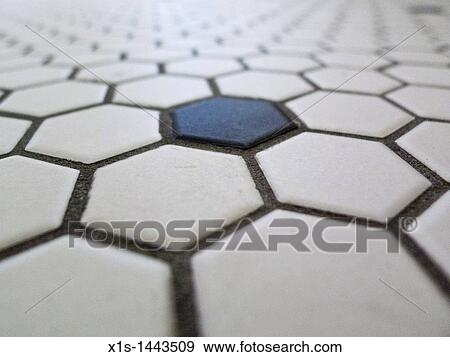 Stock Photo - Hexagon shape pattern in floor tile, with single black tile in a sea of white. Fotosearch
