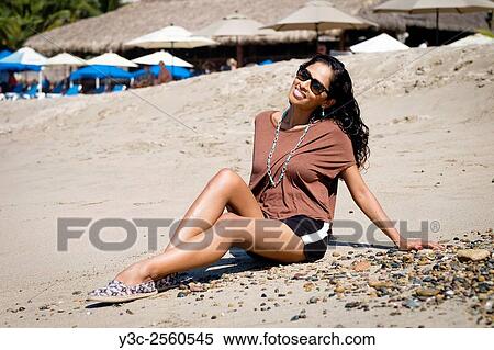 Hispanic woman in casual outfit enjoying to sit on the beach in Puerto Vallarta, Mexico. View Large Photo Image Stock Photography - Hispanic woman in casual outfit enjoying to sit on the beach in Puerto Vallarta, Mexico.. Fotosearch