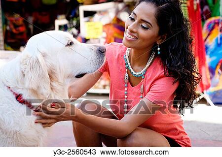 Hispanic woman with Golden Retriever dog at a street market in Puerto Vallarta, Mexico. View Large Photo Image Stock Image - Hispanic woman with Golden Retriever dog at a street market in Puerto Vallarta, Mexico.. Fotosearch