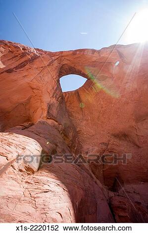 In a remote back country location in Monument Valley, a hole in the sandstone resembles an eye and is called Sun's Eye, as the sun shines brightly behind. View Large Photo Image Stock Image - In a remote back country location in Monument Valley, a hole in the sandstone resembles an eye and is called Sun's Eye, as the sun shines brightly behind.. Fotosearch