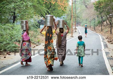 India, Agra, Women carrying water on their heads View Large Photo Image Stock Image - India, Agra, Women carrying water on their heads. Fotosearch