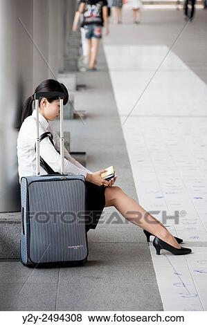 Stock Photo - Japanese girl waiting to travel at Tokyo, Japan. Fotosearch