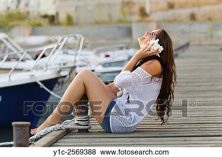 Listening to sea-shell sounds teen girl. View Large Photo Image Stock Photo - Listening to sea-shell sounds teen girl.. Fotosearch