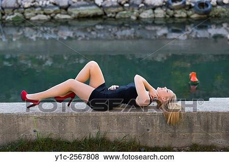 Lying down on riverside fanciful teen-girl View Large Photo Image Stock Photo - Lying down on riverside fanciful teen-girl. Fotosearch