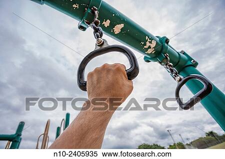 Man´s hand holding a ring on a children´s playground. View Large Photo Image Stock Photography - Man´s hand holding a ring on a children´s playground.. Fotosearch