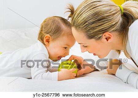 Mather and baby together with green apple in hands View Large Photo Image Stock Photograph - Mather and baby together with green apple in hands. Fotosearch