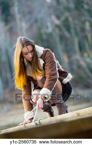 Stock Photography - Mid-adult woman pulling rope. Fotosearch