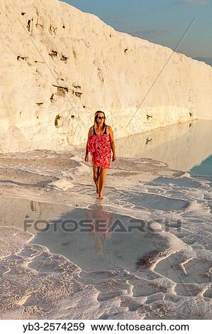 Stock Photo - Middle Aged Female Walking By A Rock Pool, Pamukkale, Denizli Provence, Turkey.. Fotosearch