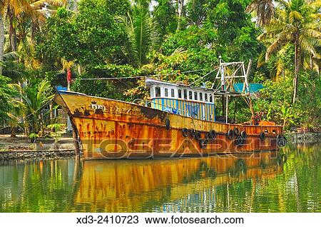 Stock Image - moored fishing boat in backwaters between Kollam and Cochin, Kerala, India.. Fotosearch