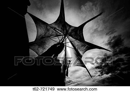 Mujer cerrando su paraguas tras la tormenta. Blanco y. View Large Photo Image Stock Photo - Mujer cerrando su paraguas tras la tormenta. Blanco y.. Fotosearch