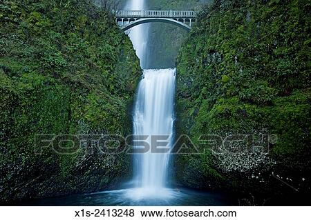 Multnomah Waterfall attracts people from around the world to see water plunge over 600 feet in two tiers. View Large Photo Image Stock Photo - Multnomah Waterfall attracts people from around the world to see water plunge over 600 feet in two tiers.. Fotosearch