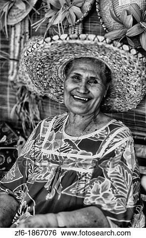 Native woman in colorful local dress in Tahiti capital of Plage de Surf Papeete in French Polynesia View Large Photo Image Stock Photograph - Native woman in colorful local dress in Tahiti capital of Plage de Surf Papeete in French Polynesia. Fotosearch