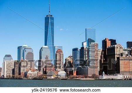 Stock Photograph - New York, USA. Daytime view on Battery Park, the Freedom Tower and the Skyline of down town Manhattan from a ferry on the Hudson River.. Fotosearch