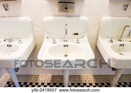 Stock Photo - New York, USA. Washbasins in the rest- and bathrooms of the main building on Ellis Island.. Fotosearch