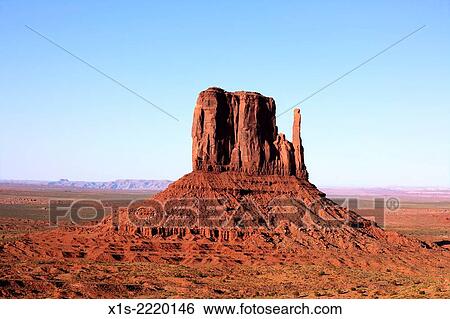 Orange light from sunset makes a mitten sandstone rock formation glow in Monument Valley. View Large Photo Image Stock Photograph - Orange light from sunset makes a mitten sandstone rock formation glow in Monument Valley.. Fotosearch