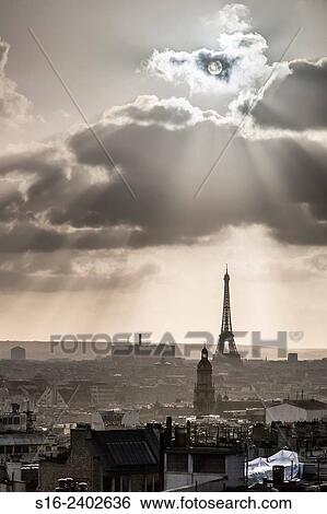 Stock Photograph - Paris gloomy skyline at dusk, with Eiffel Tower in the background, seen from a Montmartre rooftop. Fotosearch