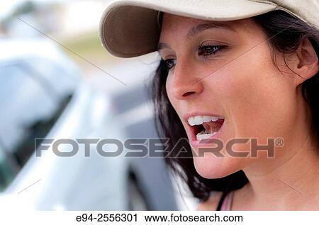 Portrait of a 38 year old brunette woman outdoors, wearing a ball cap. View Large Photo Image Stock Image - Portrait of a 38 year old brunette woman outdoors, wearing a ball cap.. Fotosearch