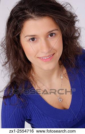 Portrait of a women in a blue long sleeve v-neck sweater in jeans on a white backdrop. View Large Photo Image Stock Photograph - Portrait of a women in a blue long sleeve v-neck sweater in jeans on a white backdrop.. Fotosearch