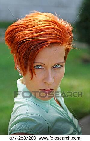 Stock Image - Portrait or a woman with red hair. Fotosearch