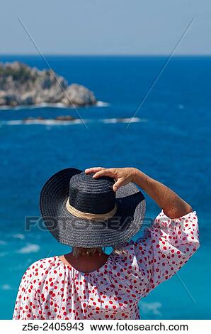 Stock Image - Rear view of a woman overlooking the sea on Pelion Peninsula, Thessaly, Greece. Fotosearch