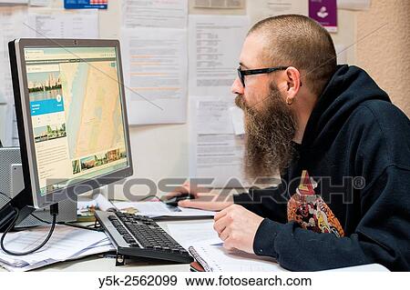 Rotetrdam, Netherlands. Man wearing large beard and glasses working behind his computer screen. View Large Photo Image Stock Photo - Rotetrdam, Netherlands. Man wearing large beard and glasses working behind his computer screen.. Fotosearch