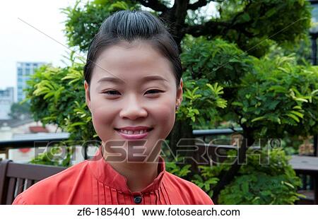 Stock Image - Saigon Ho Chi Ming City Vietnam portrait of woman in dress. Fotosearch