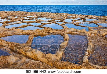 Stock Image - Salt Pans, Qbajjar Village, Gozo Island, Malta, Europe. Fotosearch