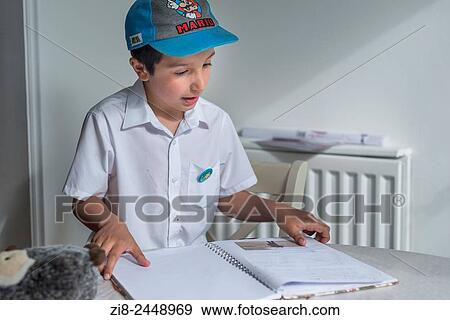 Stock Photo - Schoolboy reading out his diary.. Fotosearch