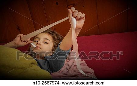 Picture - Six year old girl on her bed.. Fotosearch