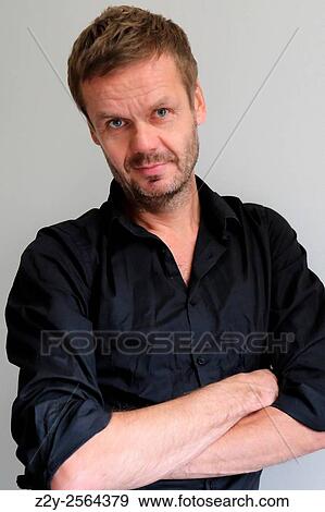 Stock Photo - Smily man with arms crossed.. Fotosearch