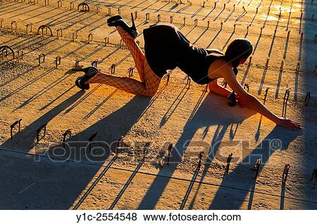 Stock Photo - Stock Photo - Pretty teen girl crawling before low sunset light. Fotosearch