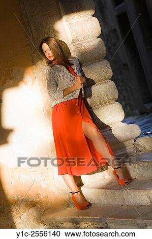 Stock Photo - Pretty young woman in long Red dress View Large Photo Image Stock Image - Stock Photo - Pretty young woman in long Red dress. Fotosearch