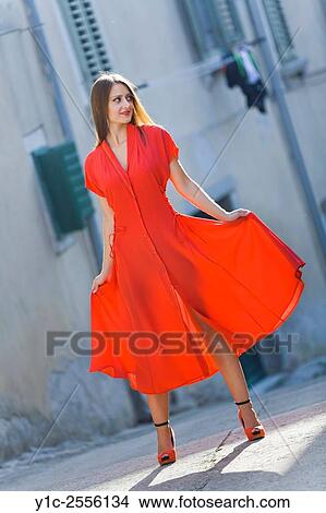 Picture - Stock Photo - Pretty young woman long Red dress spread. Fotosearch