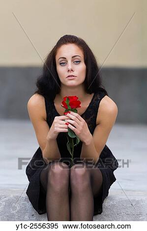 Stock Photo - Slender teen girl with rose flower in hands View Large Photo Image Stock Photography - Stock Photo - Slender teen girl with rose flower in hands. Fotosearch