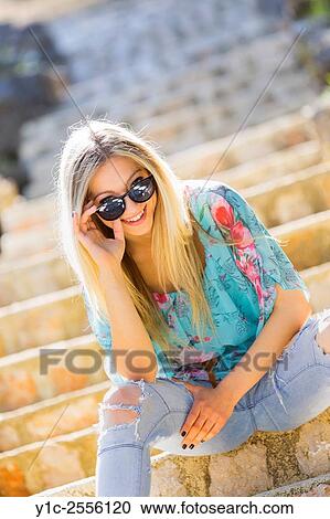 Stock Photo - Teen blonde peeping over sunglasses View Large Photo Image Stock Image - Stock Photo - Teen blonde peeping over sunglasses. Fotosearch