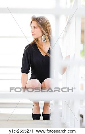 Stock Photo - Teen girl is squatting, looking aside View Large Photo Image Stock Image - Stock Photo - Teen girl is squatting, looking aside. Fotosearch