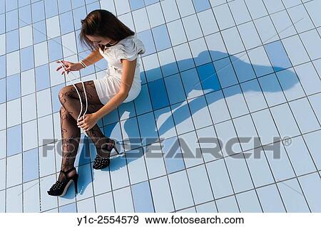 Stock Photo - Stock Photo - Young woman fanciful in empty pool. Fotosearch