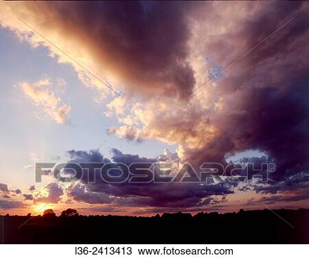 Sunset with stormy clouds. Poland View Large Photo Image Stock Image - Sunset with stormy clouds. Poland. Fotosearch