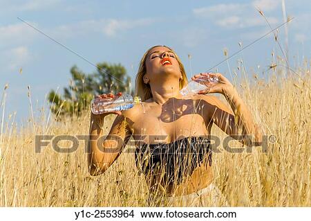 Picture - Taming heat with water young woman. Fotosearch