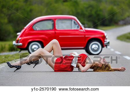 Stock Image - Teen girl spread before Red classic car. Fotosearch