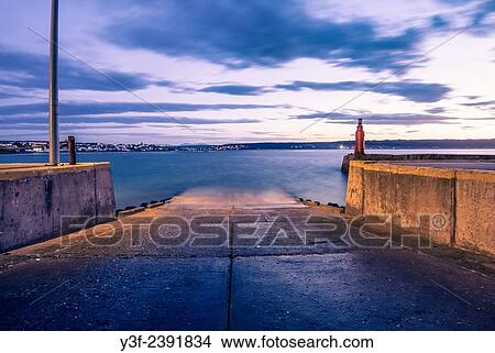 Picture - The beacon on the harbour wall. An empty slipway before the early morning boats start launching to go fishing. Still Bay, South Africa. Fotosearch