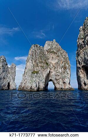 Stock Photo - The Faraglioni sea stack rocks on the Island of Capri, Campania, Italy. Fotosearch