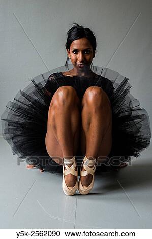 Tilburg, Netherland. Non caucausan female classical ballet dancer sitting down, studio shot. View Large Photo Image Stock Image - Tilburg, Netherland. Non caucausan female classical ballet dancer sitting down, studio shot.. Fotosearch