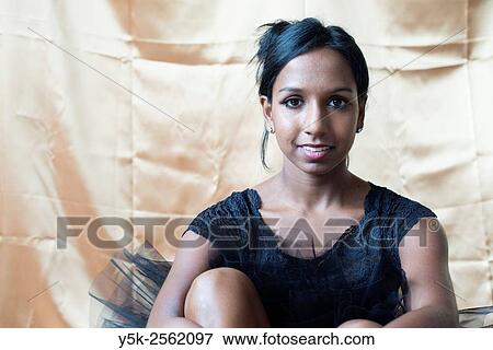 Stock Photo - Tilburg, Netherlands. Female dancer with spitzen on her feet sitting down to mount her ballet shoes.. Fotosearch