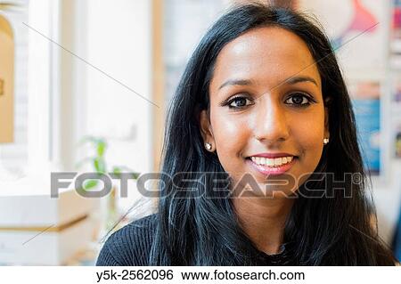 Tilburg, Netherlands. Portrait on location of a young, attactive female with Asian ethnicity sitting down in a lunch room. View Large Photo Image Stock Photograph - Tilburg, Netherlands. Portrait on location of a young, attactive female with Asian ethnicity sitting down in a lunch room.. Fotosearch
