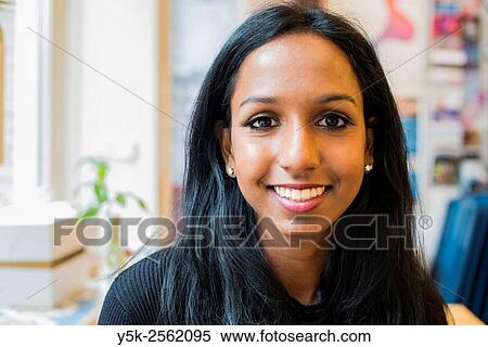 Tilburg, Netherlands. Portrait on location of a young, attactive female with Asian ethnicity sitting down in a lunch room. View Large Photo Image Stock Photography - Tilburg, Netherlands. Portrait on location of a young, attactive female with Asian ethnicity sitting down in a lunch room.. Fotosearch