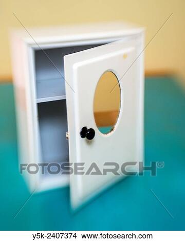 Picture - Tilburg, Netherlands. Vintage white medicine cabinet on a dining room table.. Fotosearch