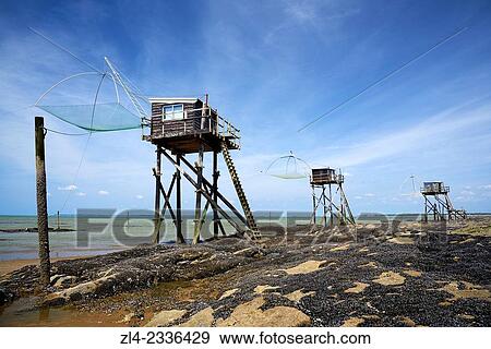Stock Photo - Traditional carrelet fishing huts with lift nets. France, Loire-Atlantique, Saint-Michel-Chef-Chef, Tharon beach.. Fotosearch