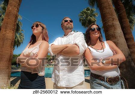 Two young women and a man stand by palm trees in Palm Springs, California. View Large Photo Image Stock Image - Two young women and a man stand by palm trees in Palm Springs, California.. Fotosearch