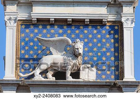 Stock Image - Venice, Venice Province, Veneto, Italy. The winged lion with the book is an iconic symbol of Venice. This one is on the Torre dellÂ´Orologio, or the Clock Tower, in Piazza San Marco. The tower dates from the 1490Â´s.. Fotosearch